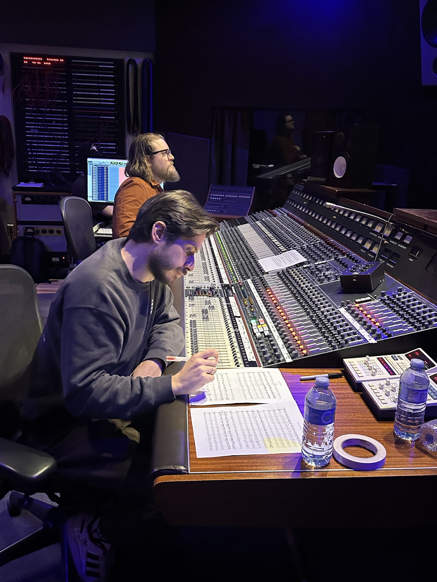 The production team reviewing the score at the recording console