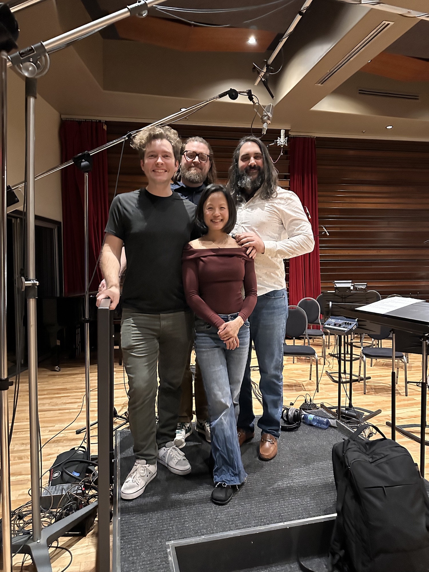 Four collaborators together in the live recording room